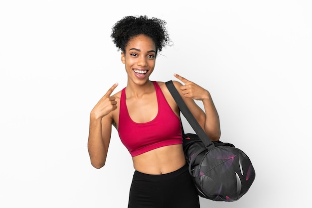 Young sport african american woman with sport bag isolated on blue background giving a thumbs up gesture