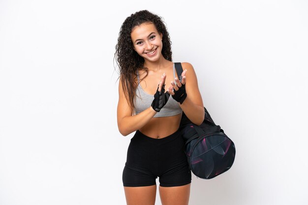 Photo young sport arab woman with sport bag isolated on white background applauding after presentation in a conference