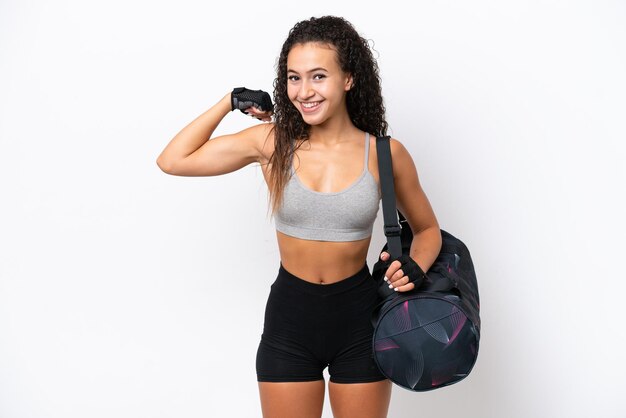 Photo young sport arab woman with sport bag isolated on white background doing strong gesture