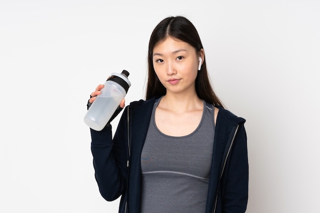 Young sport asian woman isolated on white with sports water bottle