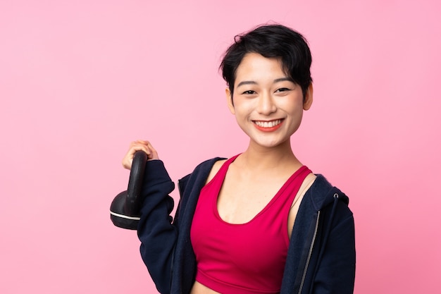 Young sport Asian woman making weightlifting with kettlebell