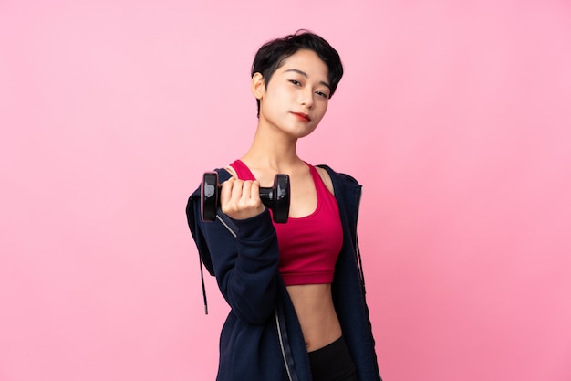 Young sport Asian woman making weightlifting