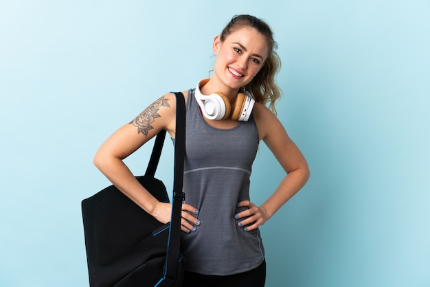 Young sport Brazilian woman with sport bag isolated 