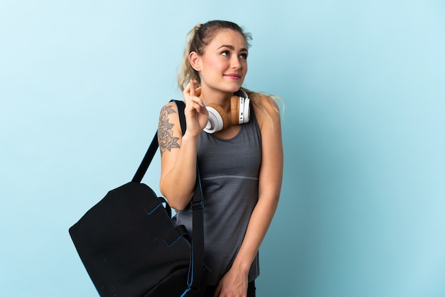 Young sport Brazilian woman with sport bag isolated 