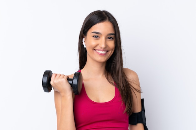 Young sport brunette woman over isolated white wall making weightlifting