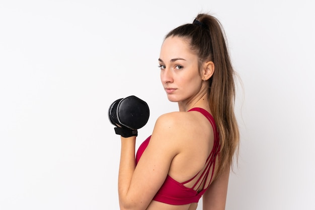 Young sport brunette woman over isolated white wall making weightlifting