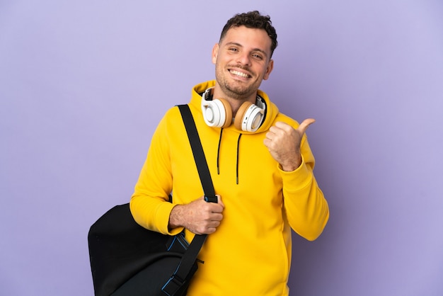 Young sport caucasian man with bag isolated