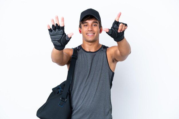 Young sport caucasian man with sport bag isolated on white background counting seven with fingers