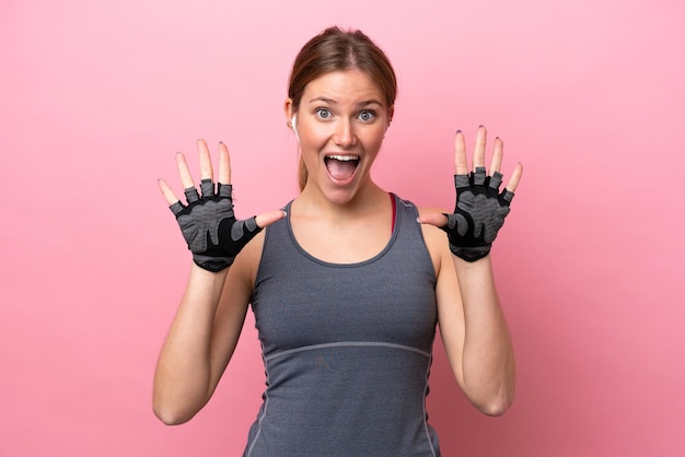 Young sport caucasian woman isolated on pink background counting ten with fingers