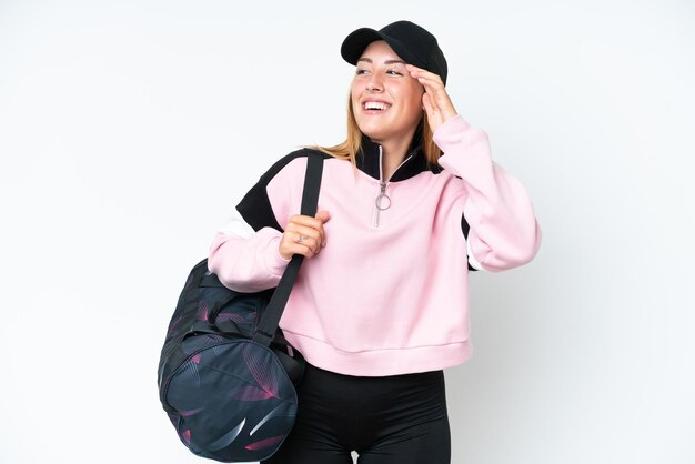 Young sport caucasian woman with sport bag isolated on white background has realized something and intending the solution