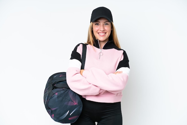 Young sport caucasian woman with sport bag isolated on white background keeping the arms crossed in frontal position