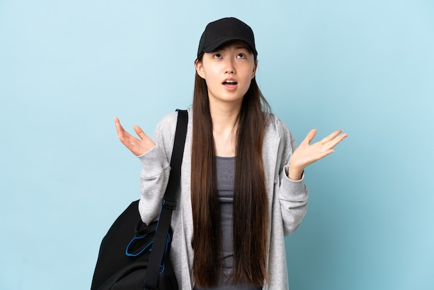 Young sport Chinese  woman with sport bag isolated