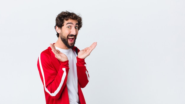 young sport dressed man feeling shocked and excited