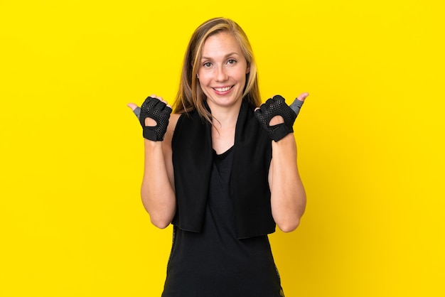Young sport english woman isolated on white background with thumbs up gesture and smiling