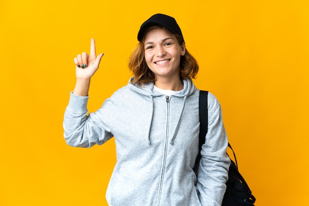 Young sport georgian woman with sport bag over isolated background pointing up a great idea