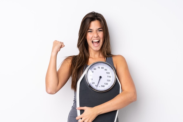 Young sport girl over isolated white wall