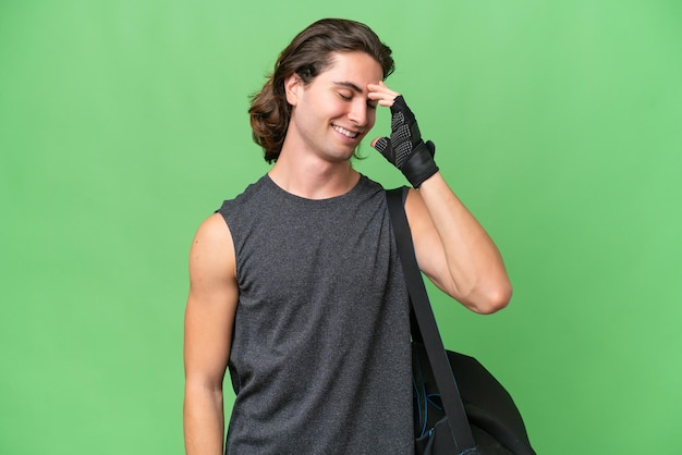 Young sport handsome man isolated on green chroma background laughing