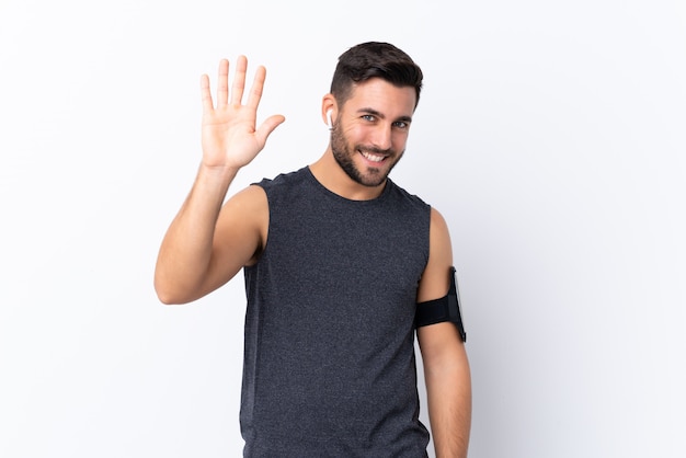 Young sport man over isolated wall 