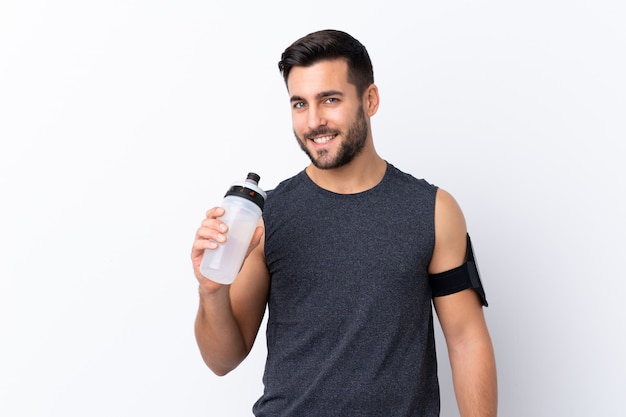 Young sport man over isolated wall 