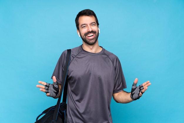 Young sport man with beard over isolated  smiling