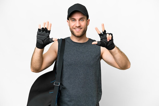 Young sport man with sport bag over isolated white background counting eight with fingers