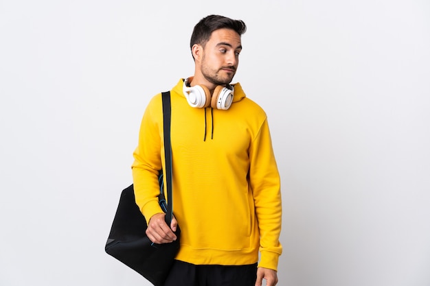 Young sport man with sport bag isolated on white  . Portrait