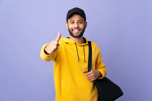 Young sport Moroccan man with sport bag isolated