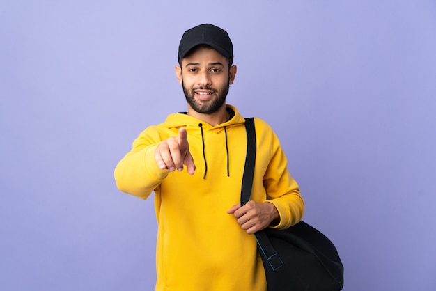 Young sport Moroccan man with sport bag isolated