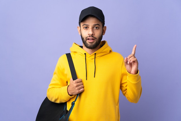 Young sport Moroccan man with sport bag isolated