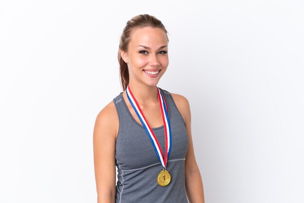 Young sport Russian girl with medals isolated on white background laughing