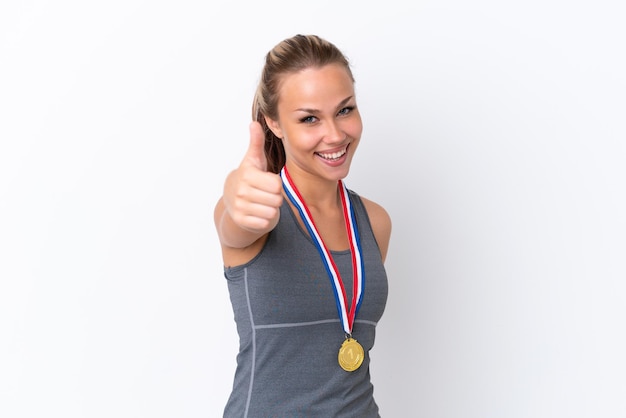 Photo young sport russian girl with medals isolated on white background with thumbs up because something good has happened