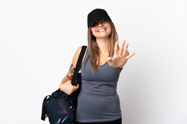 Young sport slovak woman with sport bag over isolated  counting five with fingers