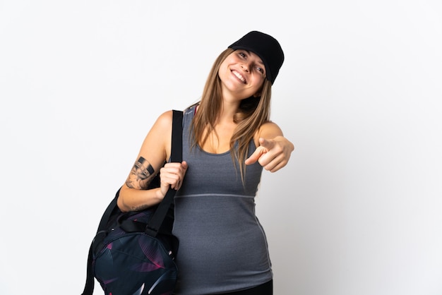 Young sport slovak woman with sport bag over isolated  pointing front with happy expression