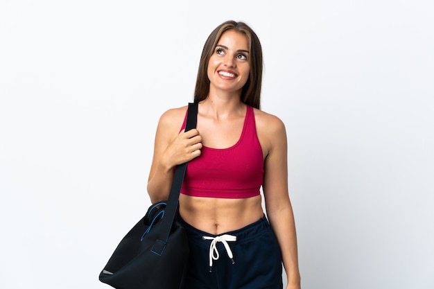 Young sport Uruguayan woman with sport bag isolated