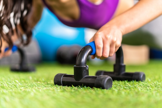 Young sport woman in a gym doing push-ups