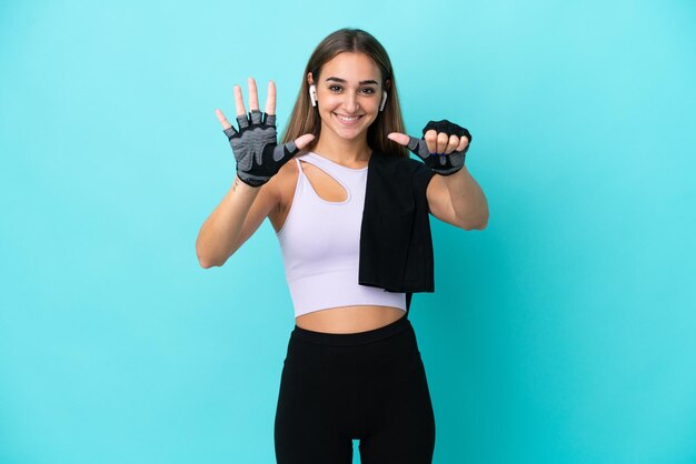 Young sport woman isolated on blue background counting six with fingers