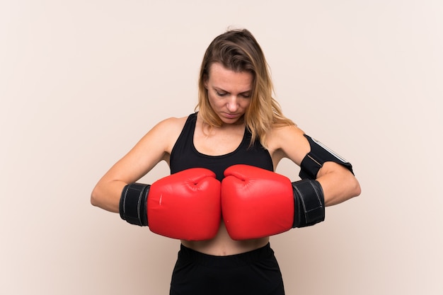 Young sport woman over isolated wall 