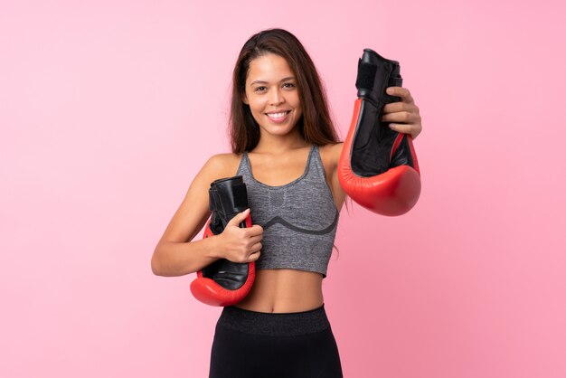 Young sport woman over isolated wall