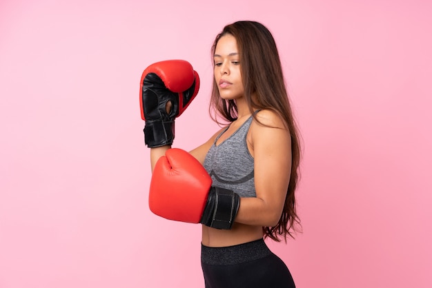 Young sport woman over isolated wall