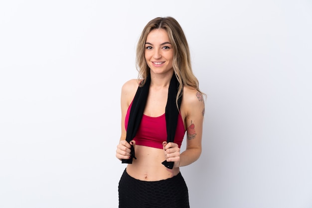 Young sport woman over isolated white wall with sport towel