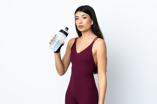 Young sport woman over isolated white with sports water bottle