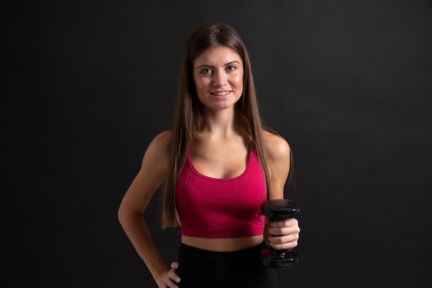 Young sport woman making weightlifting over isolated 