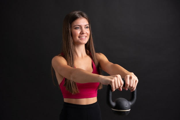 Young sport woman making weightlifting over isolated 