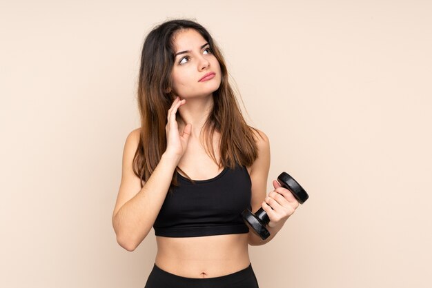 Young sport woman making weightlifting