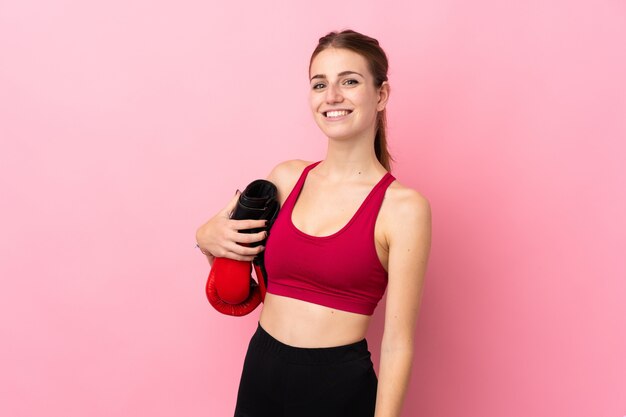 Young sport woman over isolated wall 