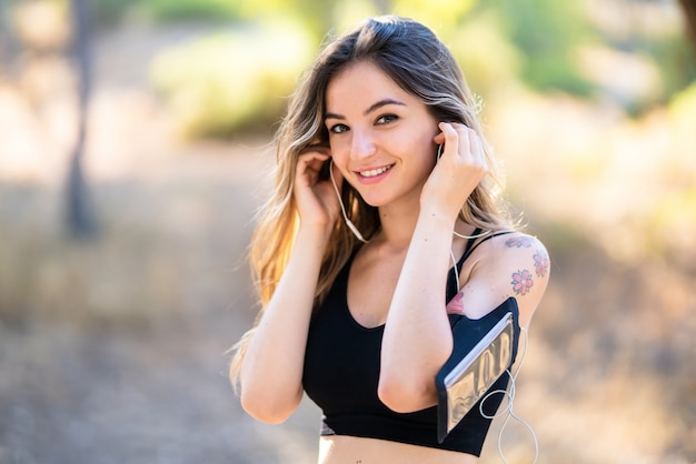 Young sport woman in a park at outdoors