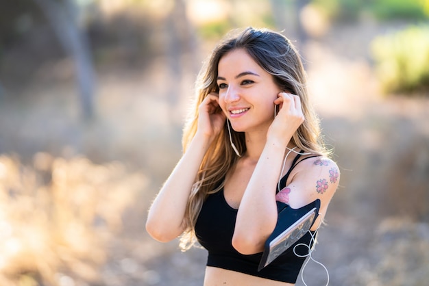 Young sport woman in a park at outdoors