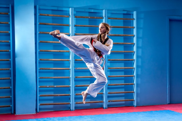 Young sport woman practicing martial art of taekwondo healthy lifestyle concept