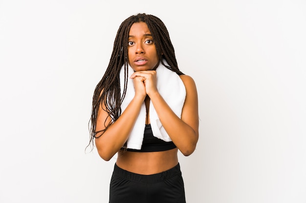 Young sport woman praying for luck, amazed and opening mouth looking to front.