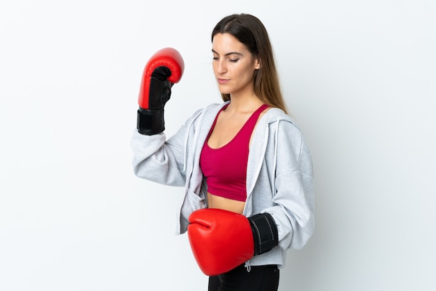 Young sport woman over wall with boxing gloves